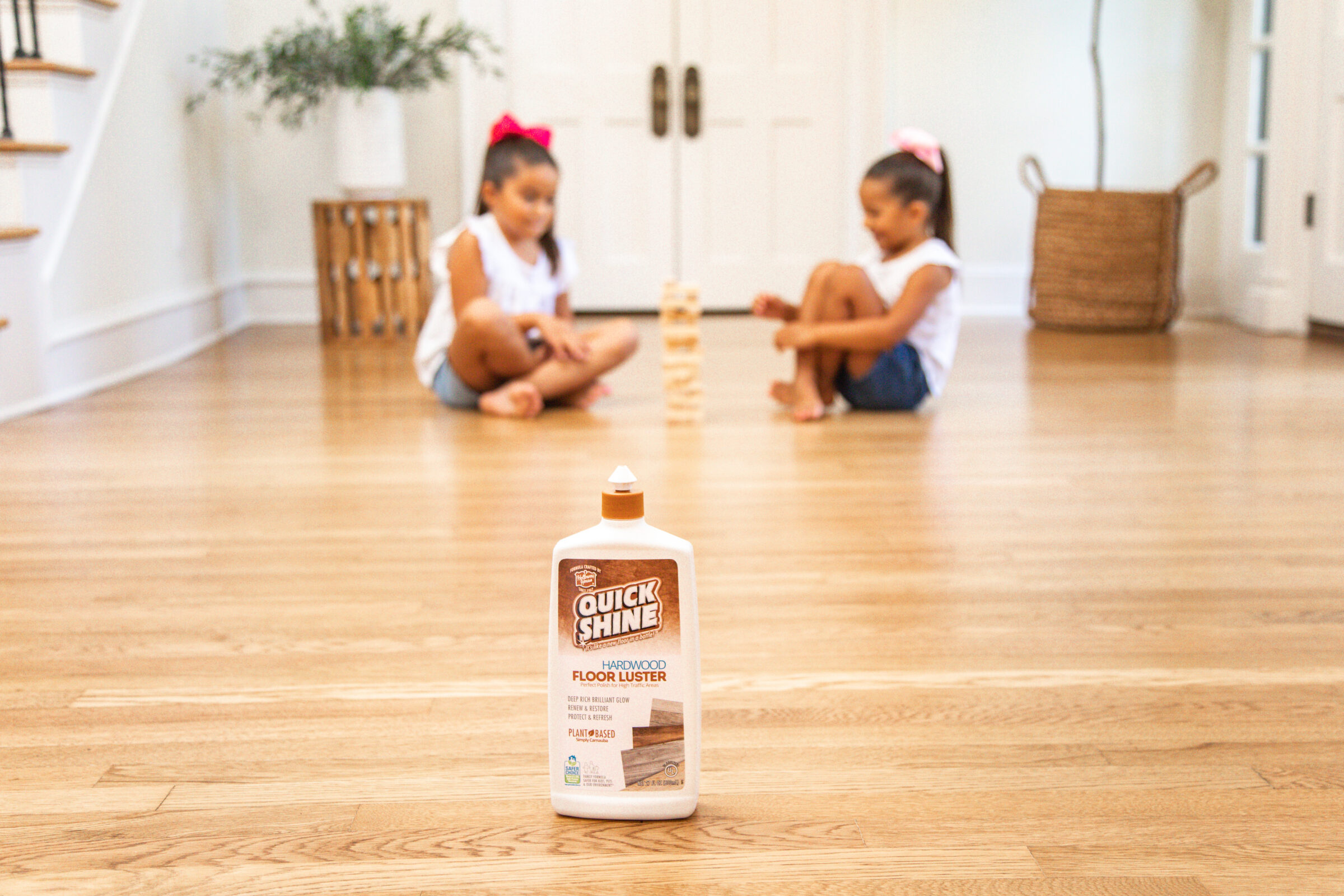 Safer Choice for kids and pets blog two girls playing blocks with Quick Shine Hardwood Floor Luster on floor in front of them